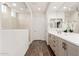 Bright bathroom with dual sinks, modern vanity, and a walk-in shower with neutral tile at 19181 W Jackson St, Buckeye, AZ 85326