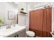 Well-lit bathroom features a single sink, shower-tub combo with curtain, and stylish decor at 19181 W Jackson St, Buckeye, AZ 85326