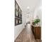 Inviting hallway with wood-look tile flooring, a picture gallery and stylish decor at 19181 W Jackson St, Buckeye, AZ 85326