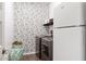 Well-organized laundry room with stylish wallpaper and modern washer and dryer at 19181 W Jackson St, Buckeye, AZ 85326