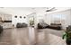 Open-concept living room boasts natural light, a ceiling fan and access to outdoor space at 19181 W Jackson St, Buckeye, AZ 85326
