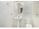 Bathroom with a pedestal sink, toilet, and decorative accents at 1926 W Busoni Pl, Phoenix, AZ 85023