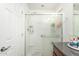 Bright bathroom features a shower with glass door and convenient built-in shelving at 1926 W Busoni Pl, Phoenix, AZ 85023