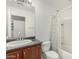 Granite vanity in this bathroom, complemented by a shower-tub combo, creates a modern touch at 1926 W Busoni Pl, Phoenix, AZ 85023