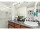 Bathroom featuring a vanity, mirror, and a glass-enclosed shower at 1926 W Busoni Pl, Phoenix, AZ 85023