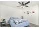 Cozy bedroom with ceiling fan and natural light is ready for relaxation at 1926 W Busoni Pl, Phoenix, AZ 85023