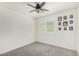 This carpeted bedroom offers ample space and natural light at 1926 W Busoni Pl, Phoenix, AZ 85023