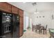 Dining area featuring a modern light fixture and a black refrigerator at 1926 W Busoni Pl, Phoenix, AZ 85023
