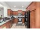Well lit kitchen features granite countertops, stainless appliances, and wood cabinets at 1926 W Busoni Pl, Phoenix, AZ 85023