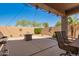 Backyard features a desert landscape, a fire pit, and outdoor lighting at 22499 N Dietz Dr, Maricopa, AZ 85138