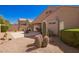 Backyard with gravel, cacti, and a covered patio area with outdoor dining furniture at 22499 N Dietz Dr, Maricopa, AZ 85138