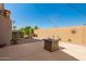 Well-maintained backyard with desert landscaping, fire pit, and ambient string lights at 22499 N Dietz Dr, Maricopa, AZ 85138
