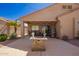 Private backyard with a covered patio, desert landscaping, and ambient lighting at 22499 N Dietz Dr, Maricopa, AZ 85138