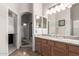 Well-lit bathroom featuring granite counters and ample storage at 22499 N Dietz Dr, Maricopa, AZ 85138