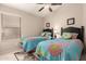 Shared bedroom featuring two twin beds with colorful quilts at 22499 N Dietz Dr, Maricopa, AZ 85138