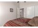 Cozy bedroom features a patterned bedspread, closet, and attached bathroom access at 22499 N Dietz Dr, Maricopa, AZ 85138