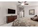 Comfortable bedroom featuring a large TV and dark wood dresser at 22499 N Dietz Dr, Maricopa, AZ 85138