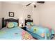 Shared bedroom featuring two twin beds with colorful quilts at 22499 N Dietz Dr, Maricopa, AZ 85138