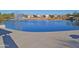A large community pond features water fountain, grassy lawn, and walking path at 22499 N Dietz Dr, Maricopa, AZ 85138