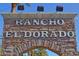 Stone community sign welcomes residents and guests to 'Rancho El Dorado' at 22499 N Dietz Dr, Maricopa, AZ 85138