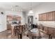 Charming dining area adjacent to the kitchen, featuring a glass table and seamless flow at 22499 N Dietz Dr, Maricopa, AZ 85138