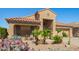 Charming home features desert landscaping with cacti, a tile roof, and a cozy front porch at 22499 N Dietz Dr, Maricopa, AZ 85138
