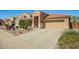 Charming single-story home features desert landscaping, a tile roof, and a two-car garage at 22499 N Dietz Dr, Maricopa, AZ 85138