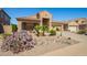 Charming home features desert landscaping with cacti, a tile roof, and a cozy front porch at 22499 N Dietz Dr, Maricopa, AZ 85138