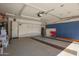 Spacious garage featuring storage cabinets, epoxy floors, and ample room for vehicles at 22499 N Dietz Dr, Maricopa, AZ 85138