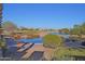 Picturesque golf course view featuring a pond, lush landscaping, and clear blue skies, perfect for golf enthusiasts at 22499 N Dietz Dr, Maricopa, AZ 85138