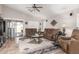 Open living room features neutral walls, tile floors, ceiling fan and access to the patio at 22499 N Dietz Dr, Maricopa, AZ 85138