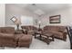 Inviting living room features plush seating, warm lighting, and carpet flooring at 22499 N Dietz Dr, Maricopa, AZ 85138