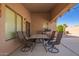 Covered patio features an outdoor dining set and a grill for entertaining at 22499 N Dietz Dr, Maricopa, AZ 85138