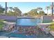 Beautiful community water feature surrounded by lush landscaping, and mature palm trees at 22499 N Dietz Dr, Maricopa, AZ 85138
