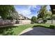 Spacious backyard with lush lawn, mature trees, and block fence at 228 W Bolero Dr, Tempe, AZ 85284