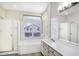 Elegant bathroom featuring a soaking tub, dual shower heads, and stylish vanity at 228 W Bolero Dr, Tempe, AZ 85284