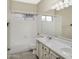 Bright bathroom featuring a double vanity, large mirror, and shower-tub combo at 228 W Bolero Dr, Tempe, AZ 85284