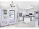 Bright kitchen featuring white cabinetry, an island, and access to the backyard at 228 W Bolero Dr, Tempe, AZ 85284