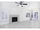 Open living room featuring a fireplace, tile flooring, and plantation shutters at 228 W Bolero Dr, Tempe, AZ 85284