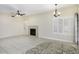 Spacious living room featuring a fireplace, plantation shutters, and ceiling fan at 228 W Bolero Dr, Tempe, AZ 85284
