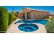Serene backyard featuring a beautiful pool, spa, and landscaped garden, creating an oasis for relaxation and recreation at 2741 N 137Th Ave, Goodyear, AZ 85395
