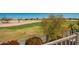 Serene balcony with golf course views, featuring lush greenery, desert landscaping, and colorful flowers at 2741 N 137Th Ave, Goodyear, AZ 85395