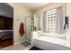 This bathroom features a glass shower, garden tub, and frosted window for natural light at 2741 N 137Th Ave, Goodyear, AZ 85395