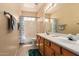 Bathroom featuring a double sink vanity with wood cabinets, tile floors, and bath tub at 2741 N 137Th Ave, Goodyear, AZ 85395