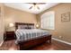 Bright bedroom with hardwood floors, ceiling fan, and natural light from a shuttered window at 2741 N 137Th Ave, Goodyear, AZ 85395