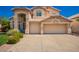 Beige two-story home with a two-car garage and a well-maintained front yard at 2741 N 137Th Ave, Goodyear, AZ 85395