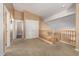 Upstairs hallway with carpet flooring, a wooden banister, and closet for plenty of storage at 2741 N 137Th Ave, Goodyear, AZ 85395