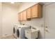 Functional laundry room with utility sink, cabinets and appliances at 2741 N 137Th Ave, Goodyear, AZ 85395