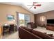 Inviting upstairs loft with a comfortable seating area and a sliding glass door that leads to a balcony at 2741 N 137Th Ave, Goodyear, AZ 85395
