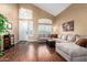Spacious living room featuring hardwood floors, vaulted ceilings, and abundant natural light at 2741 N 137Th Ave, Goodyear, AZ 85395